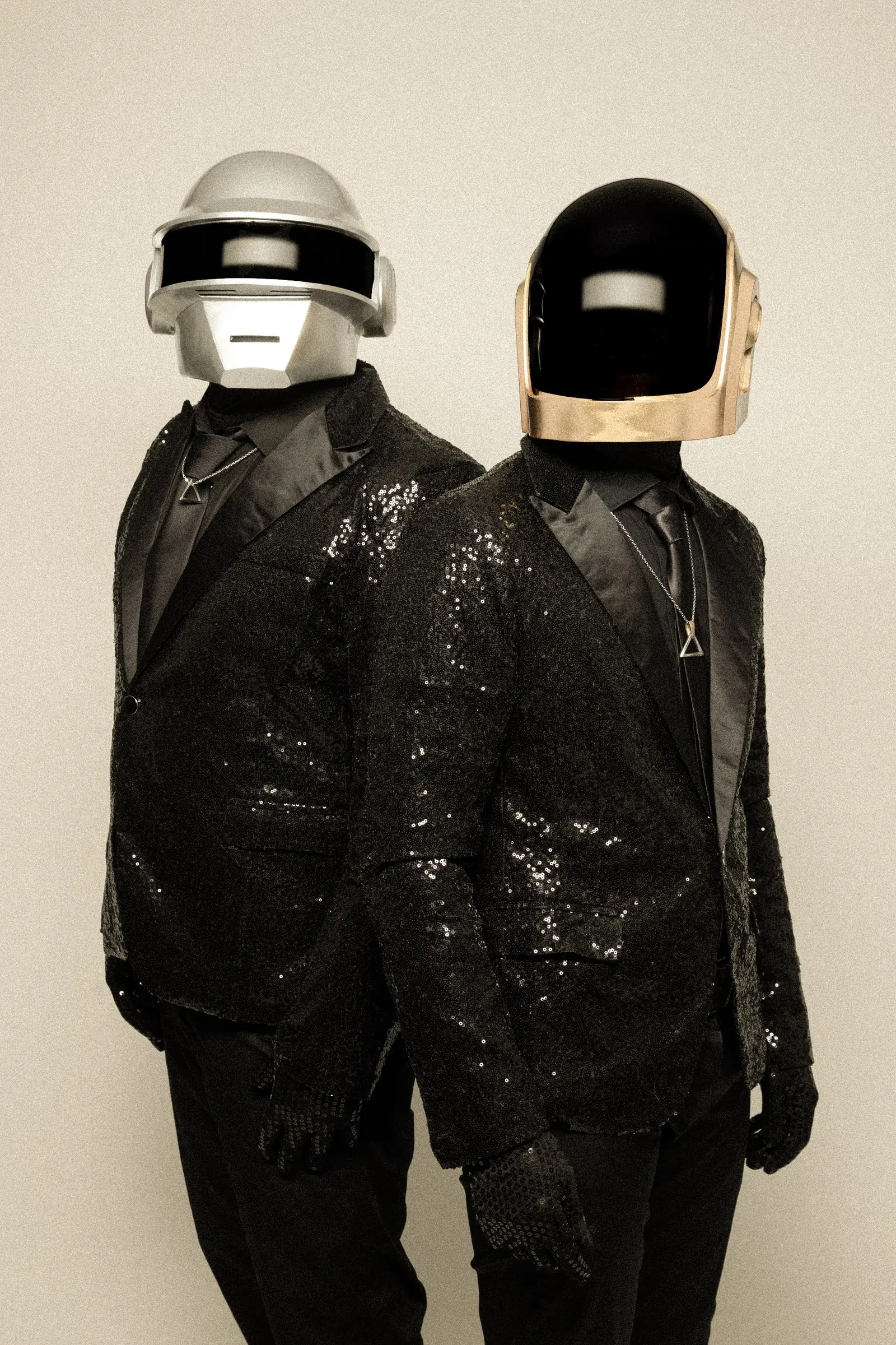 The two performers in sequin jackets, vertical portrait
