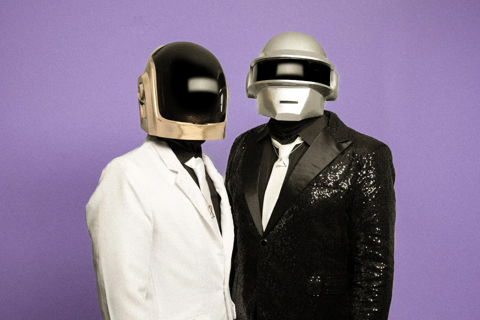 White jacket and black sequin jacket against a purple backdrop